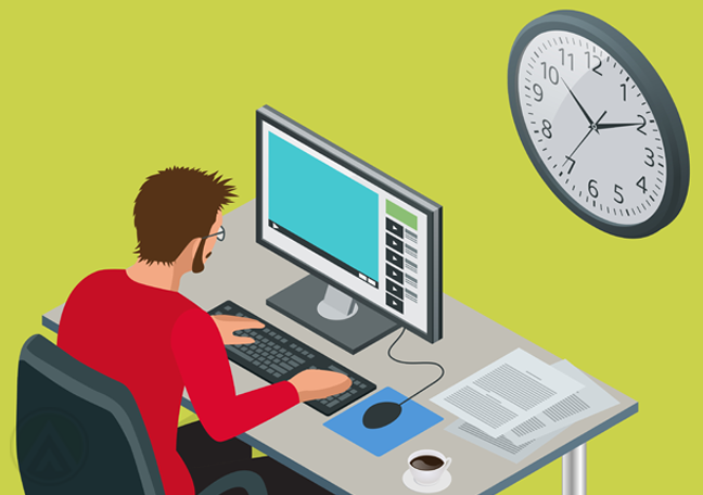 office employee using computer near wall clock