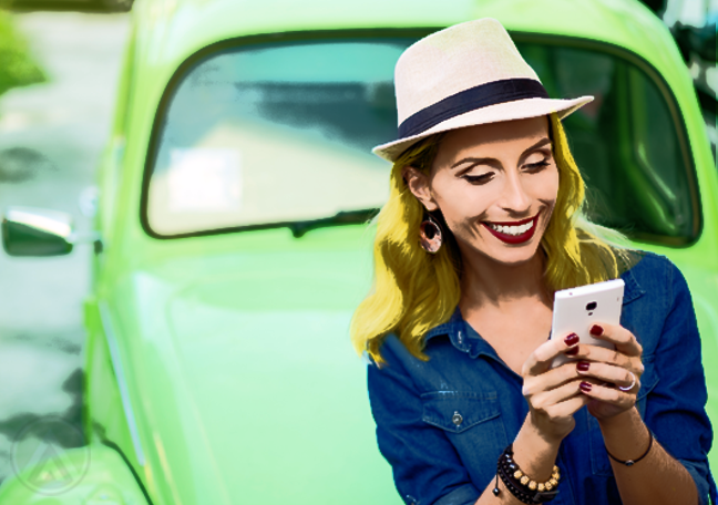 woman in blue using smartphone by car outdoors