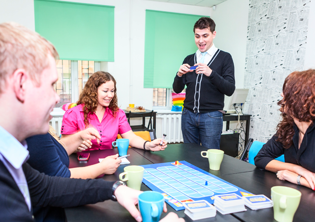 young people having fun playing board games