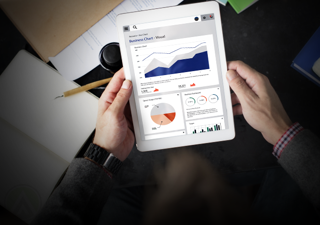businessman holding tablet studying reports charts graphs