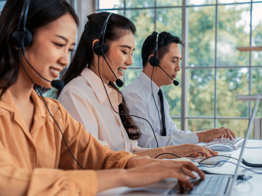diverse multilingual call center CX agents assisting customers in contact center