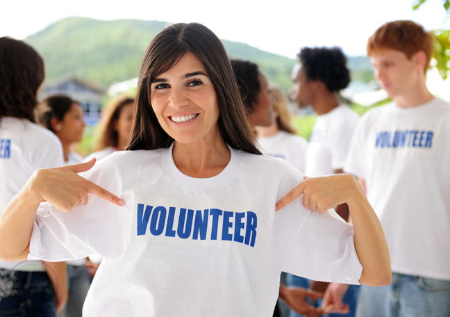 initiative volunteers having fun pointing to shirt