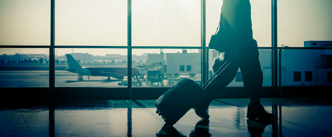 man walking with luggage handcarry in airport runway airplane outside