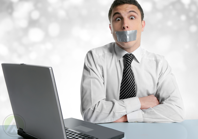 surprised office employee taped mouth by laptop