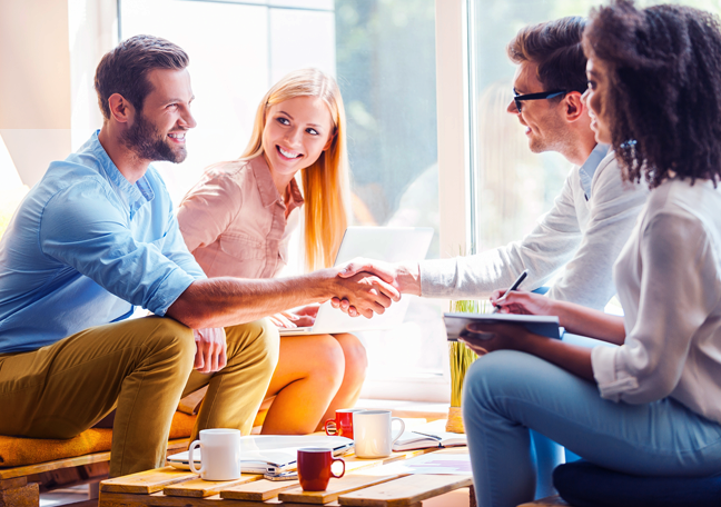 young people shaking hands with business team