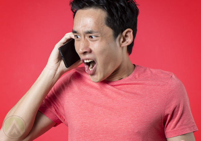 asian man frustrated with phone call