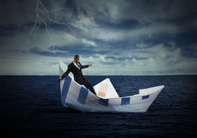 businessman sailing in paper boat troubled waters dark clouds in sky 