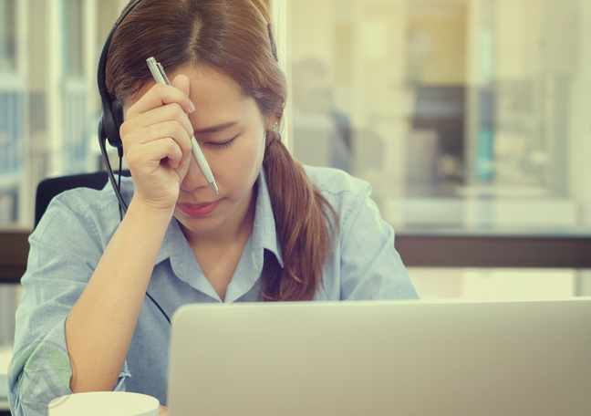 customer service agent working with headache