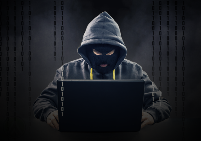 cybercriminal hacker working on laptop