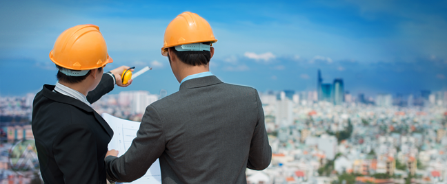 engineers looking over city scape holding construction plans