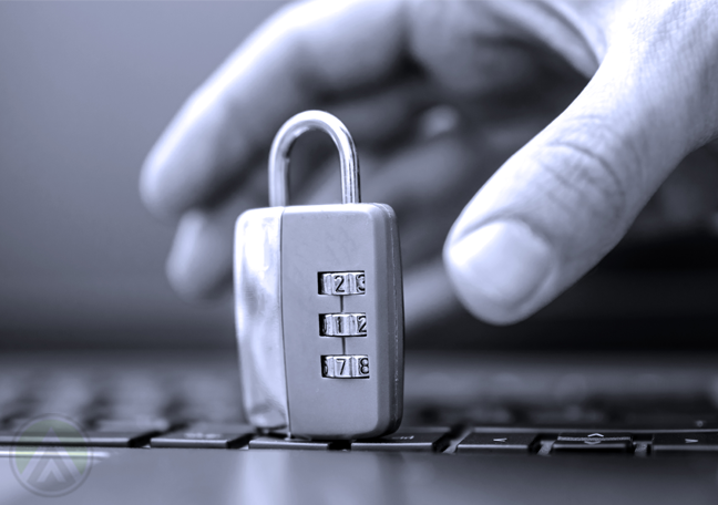 hand grabbing padlock on top laptop