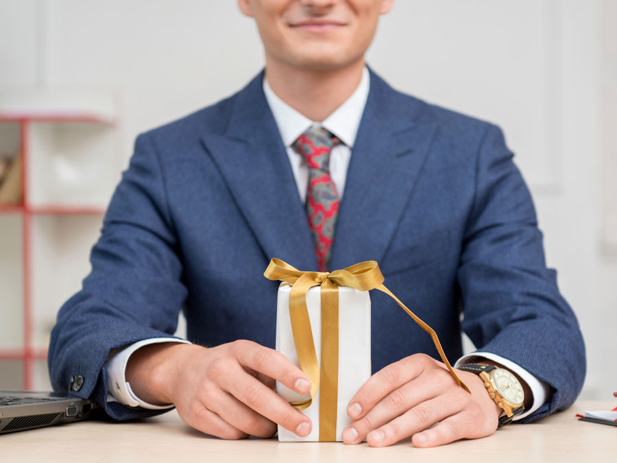 happy employee holding gift