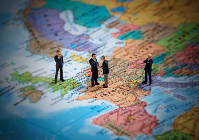 miniature businessmen standing on world map- international banking finance
