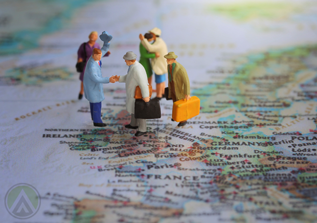 miniature-tourist-figures-standing-on-map