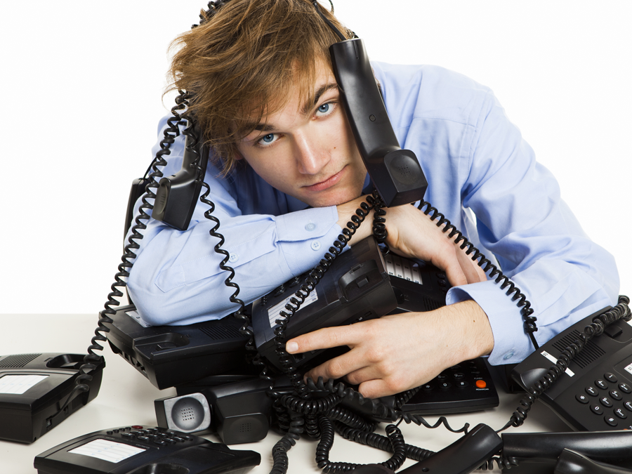 sad businessman on entangled telephones