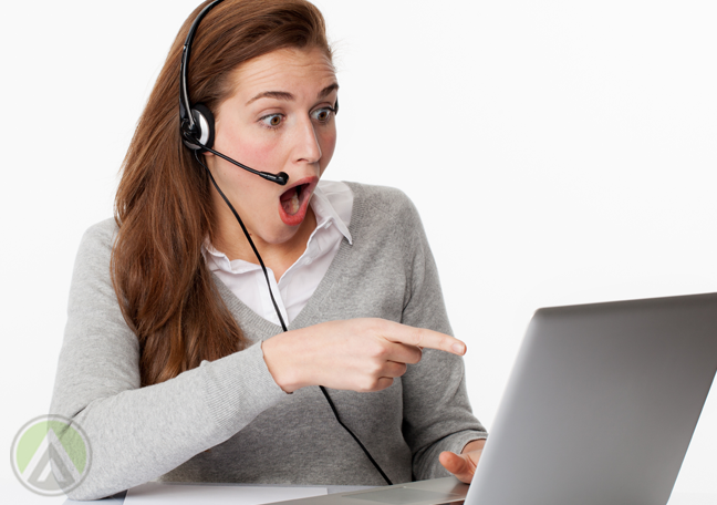 shocked woman pointing to laptop