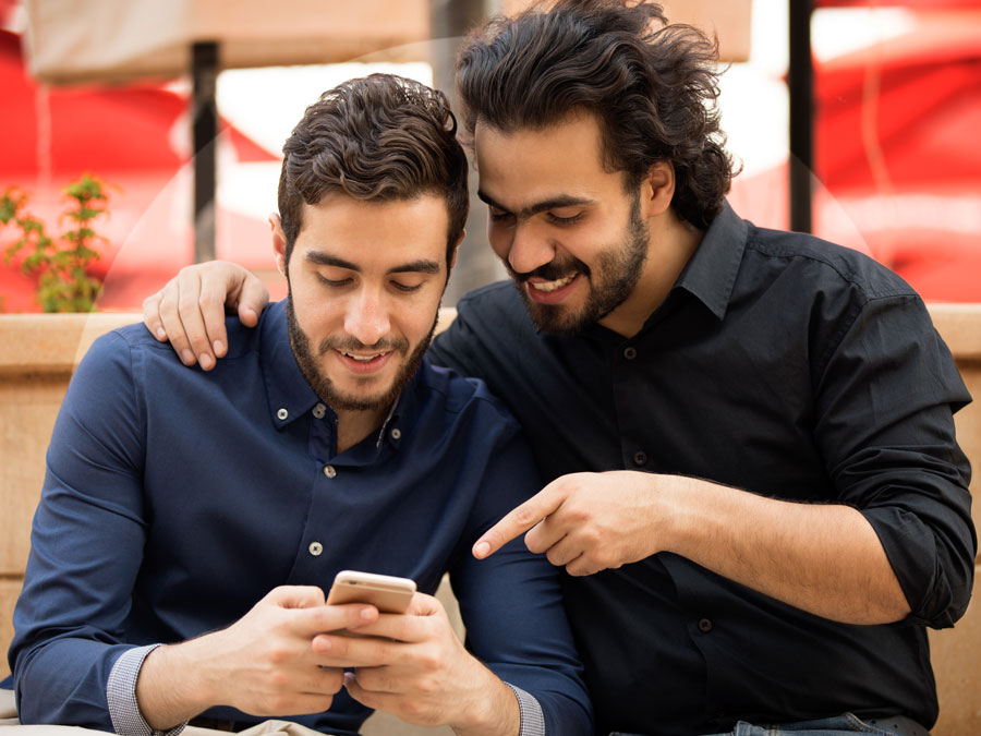 Arabic friends talking about smartphone use