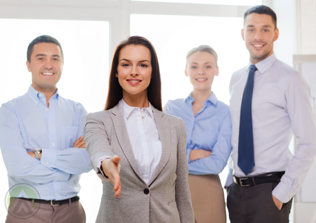 businesswoman reaching out to reader with team at the back