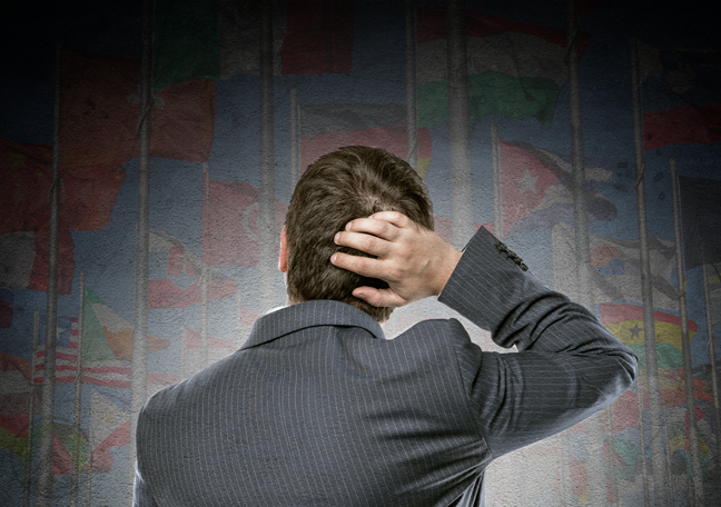 confused businessman back scratching looking up blurred dark maps of the nation