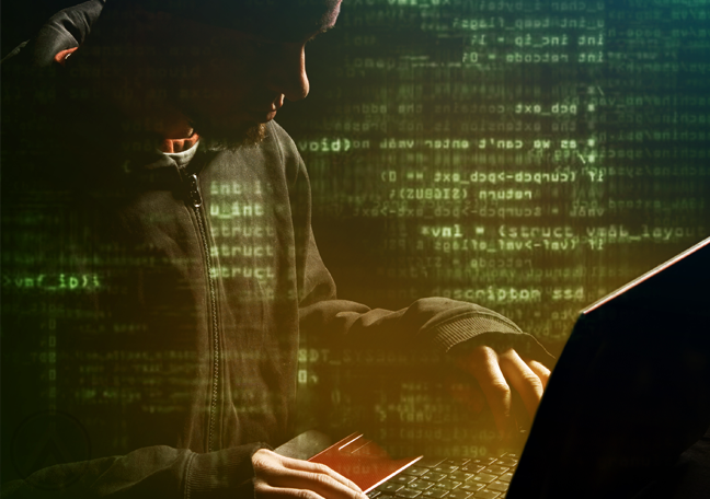 hacker useing laptop in dark