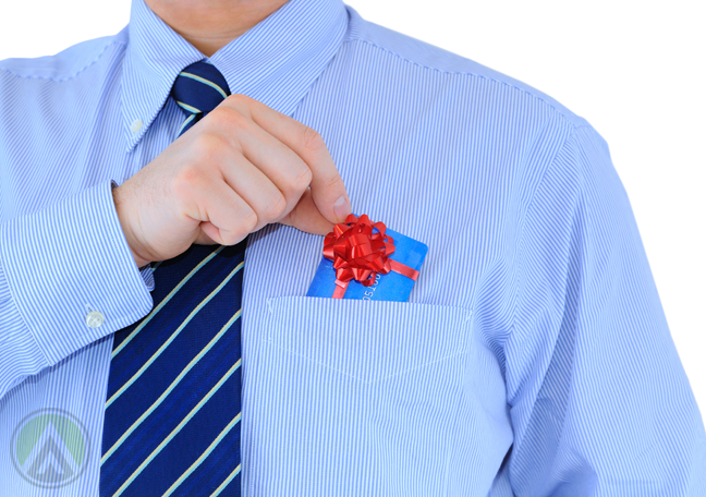office employee putting tiny gift with ribbon into shirt pocket