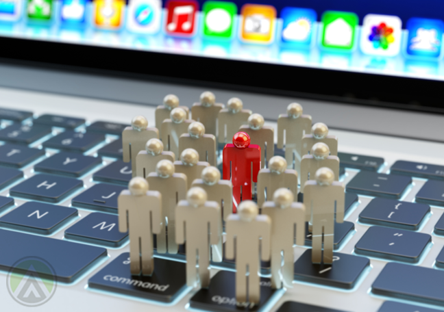 red figure surrounded by white plastic shapes standing on laptop computer keyboard