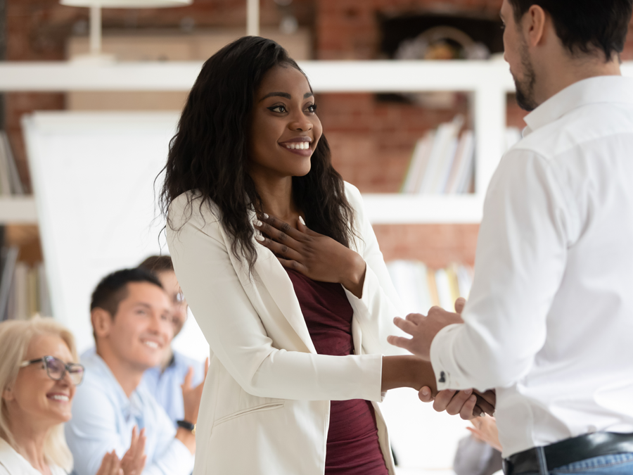 call center team applauding customer support agent receiving promotion