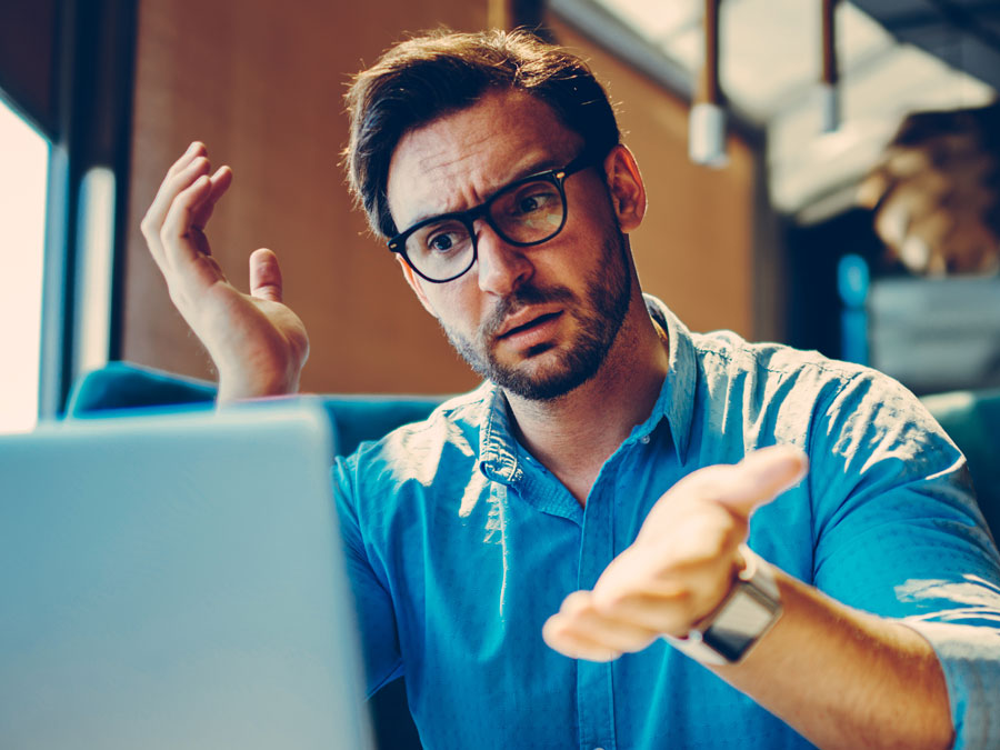 confused annoyed frustrated man using laptop