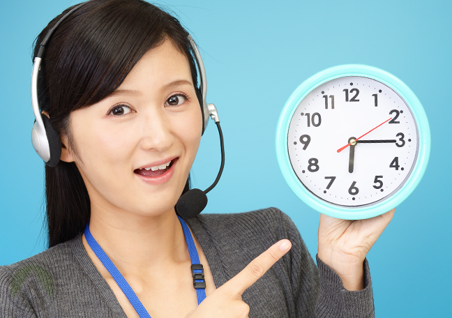 excited female call center agent pointing to clock