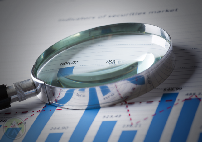 magnifying lens on printed report chart graph