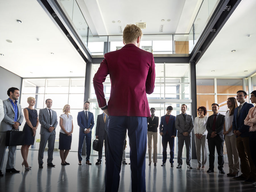 organizational culture leader standing before multilingual team