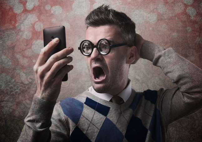 shocked man looking at smartphone