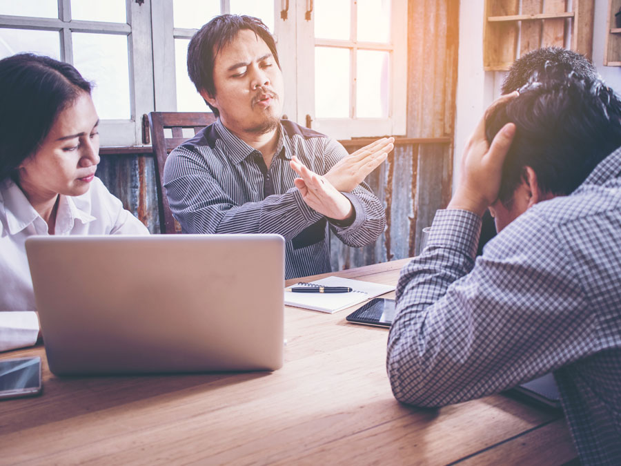 business executives in disagreement during meeting