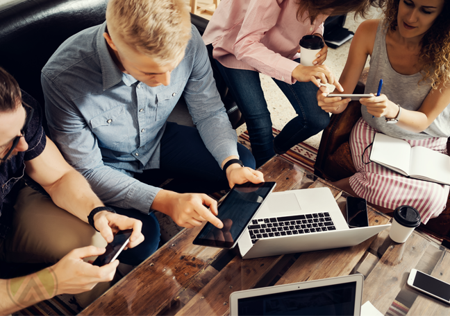 business team working together using laptop smartphone tablet