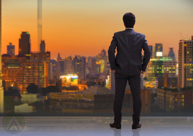 businessman looking over cityscape