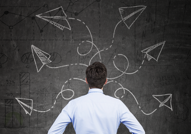 businessman standing looking at blackboard of calculations flying paper planes math 