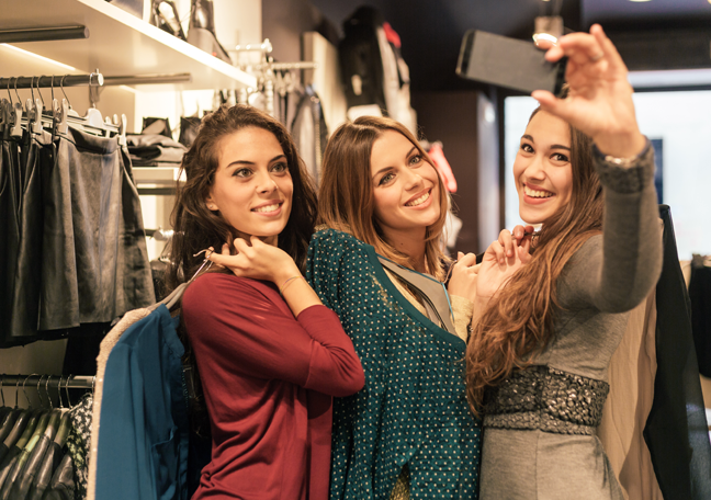 girl group friends taking selfie shopping dresses