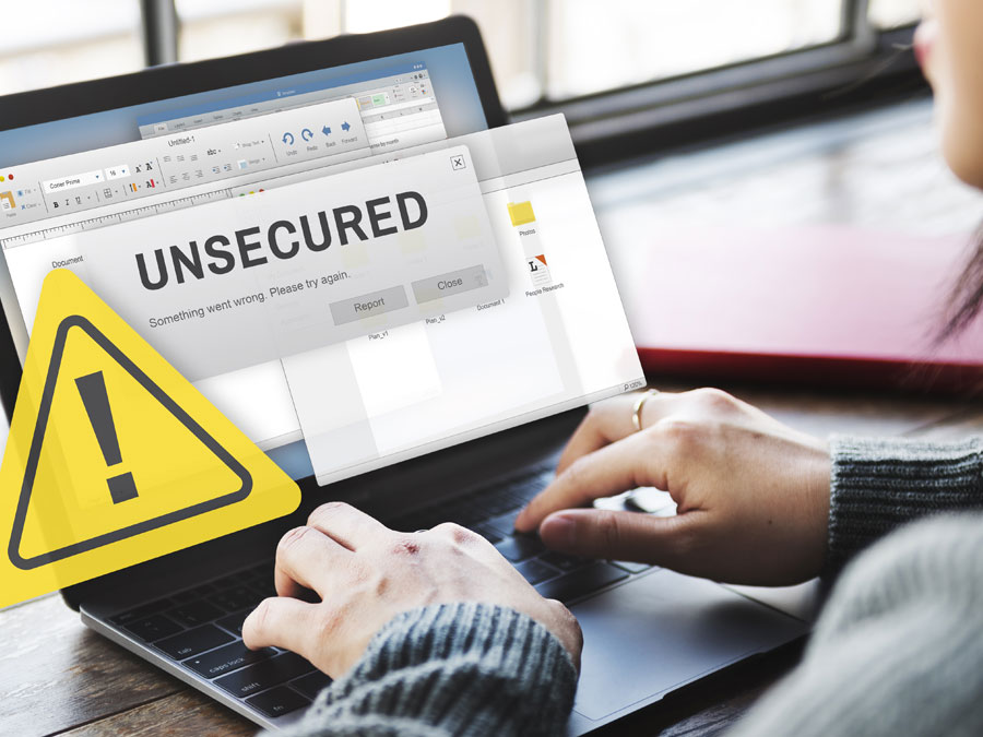 woman using laptop with warning signs unsecured data security