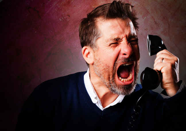 man in rage shouting over the phone