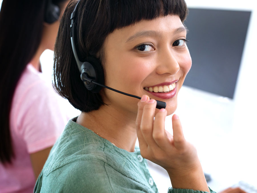 smiling call center agent helping a customer during a call