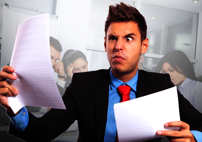 confused businessman reading printed report documents tired coworkers in background