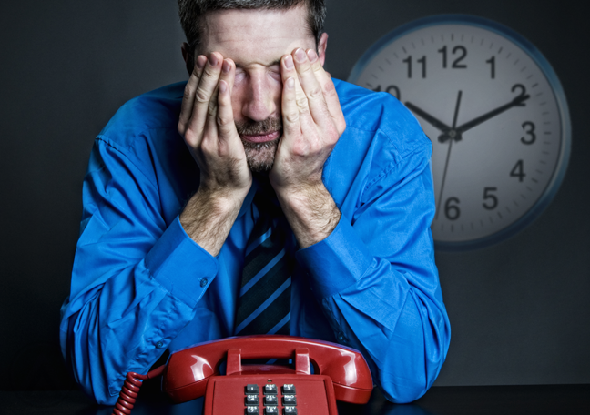 impatient businessman waiting for phone call in dark