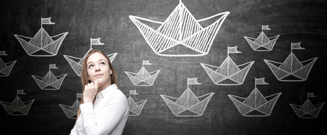 thinking team leader in front chalk board paper boat drawings 