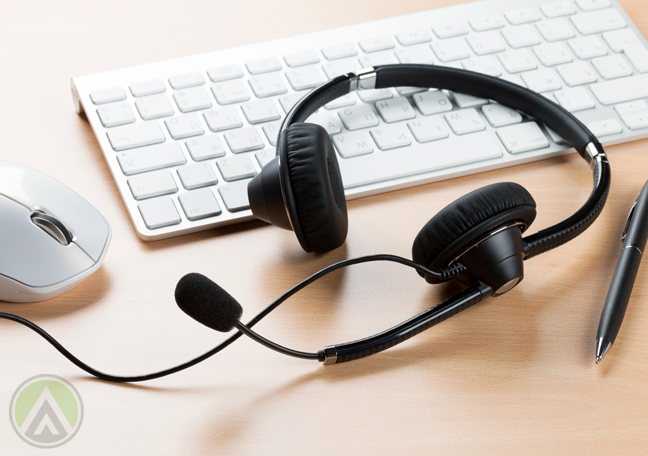 usused call center headset on computer keyboard