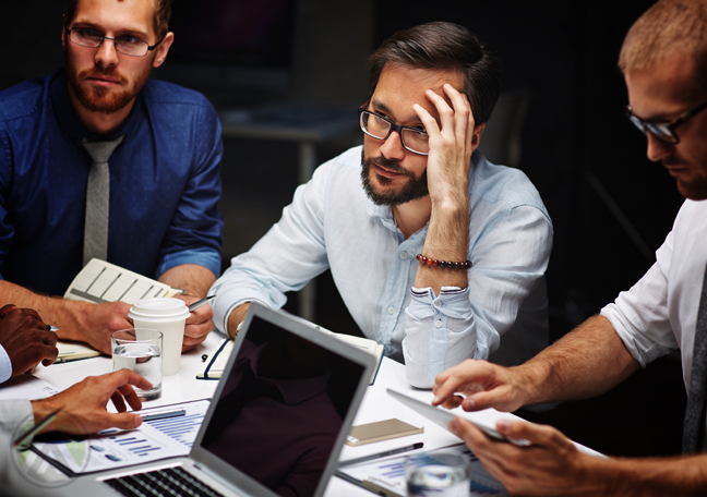 worried business executives in meeting