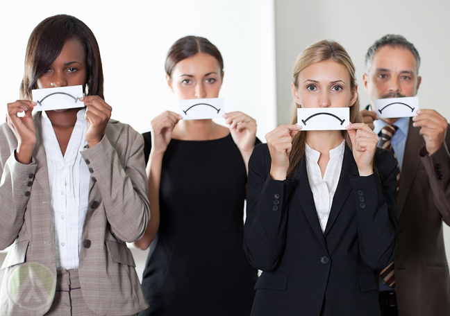 business team holding paper sad face to mouth 