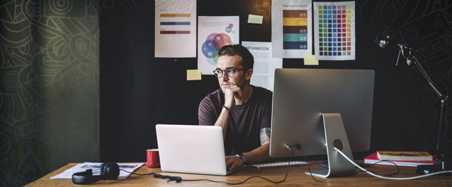 designer thinking deeply by computer in dark room