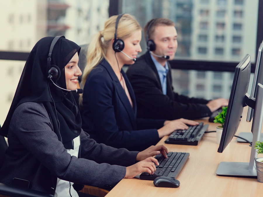 diverse customer support representatives assisting customers over the phone in a call center