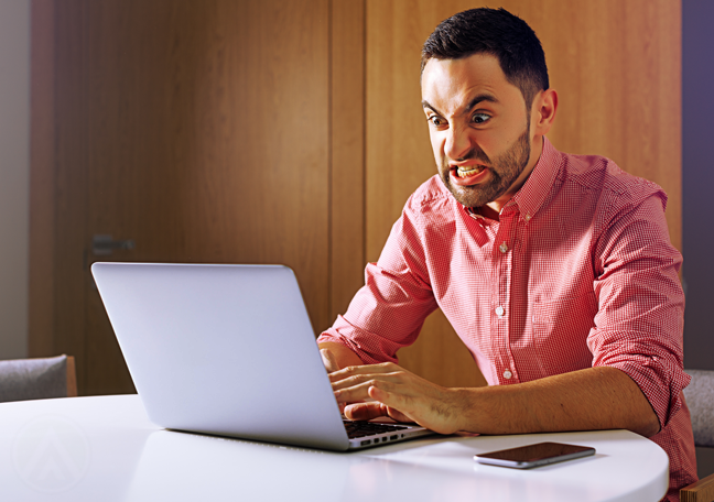 man angry at laptop