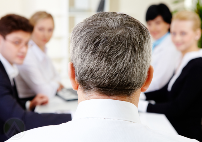 middle aged businessman turn back in meeting with business team